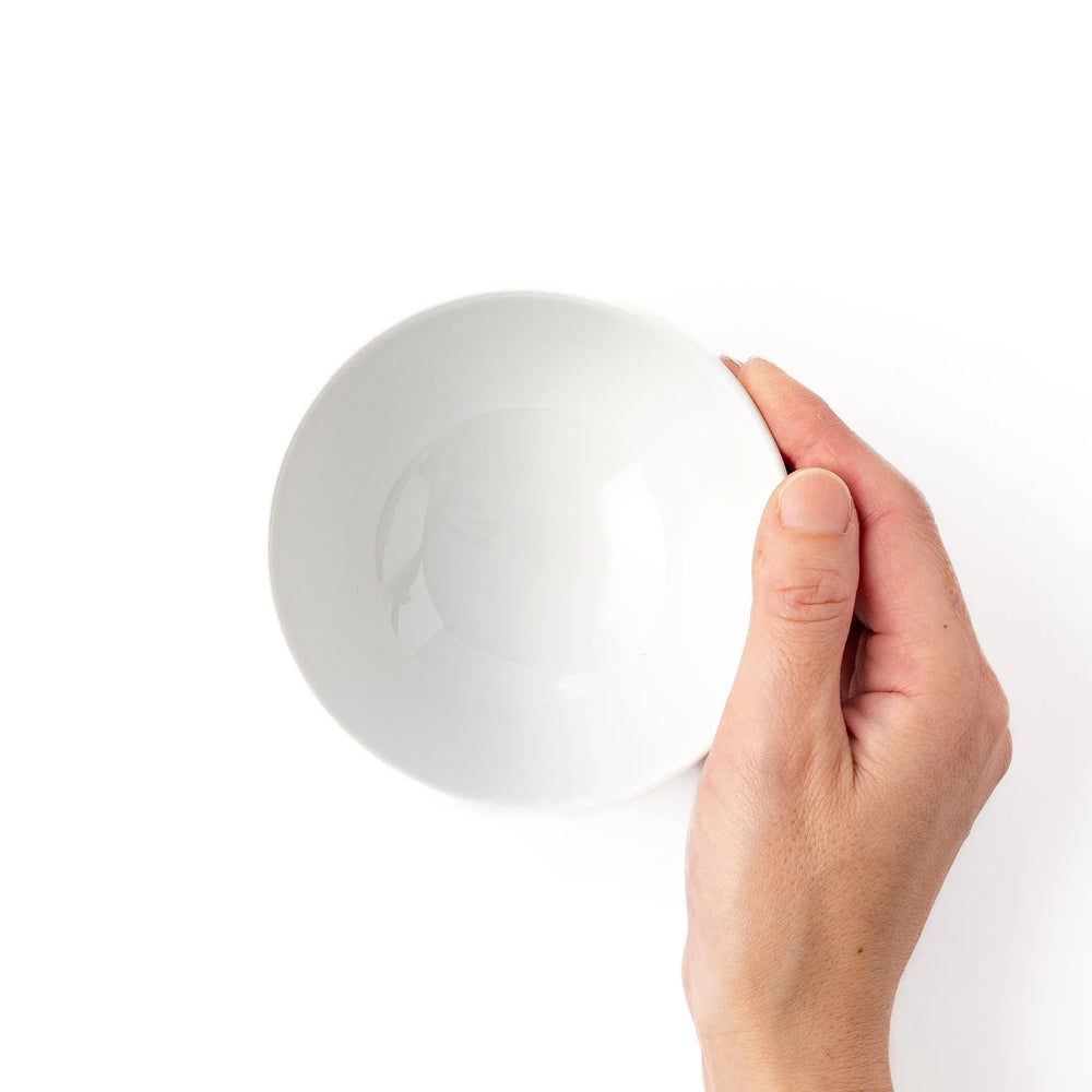 White ceramic kids rice bowl featuring red and white Shinkansen bullet train illustration, round footed base