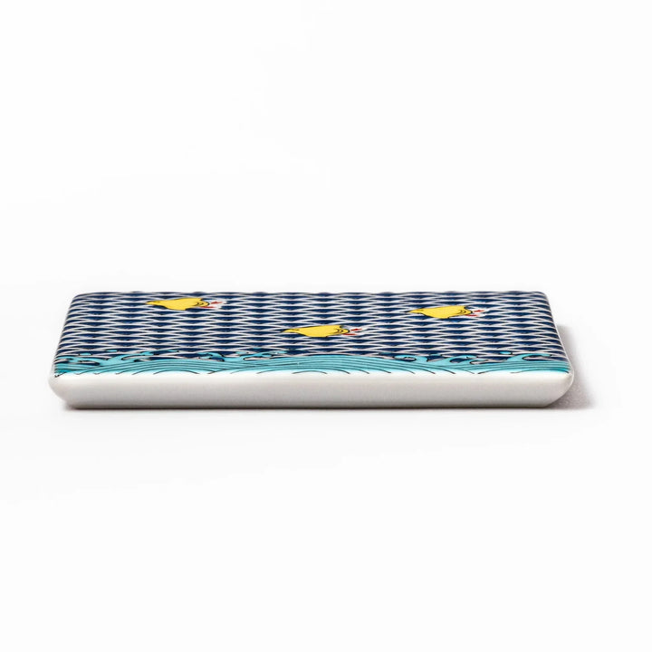 Square Japanese ceramic coaster with blue wave pattern and yellow shorebirds for artistic stylish dining.