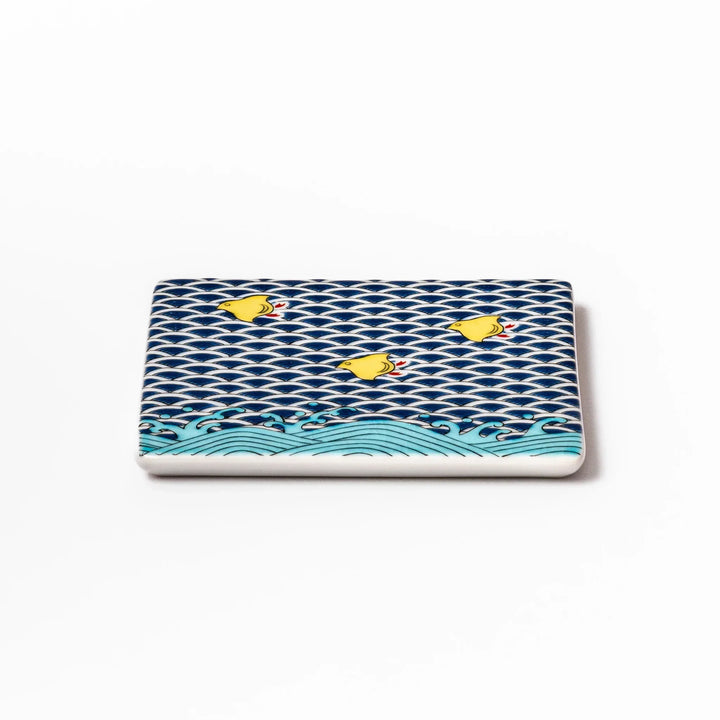 Square Japanese ceramic coaster with blue wave pattern and yellow shorebirds for artistic stylish dining.