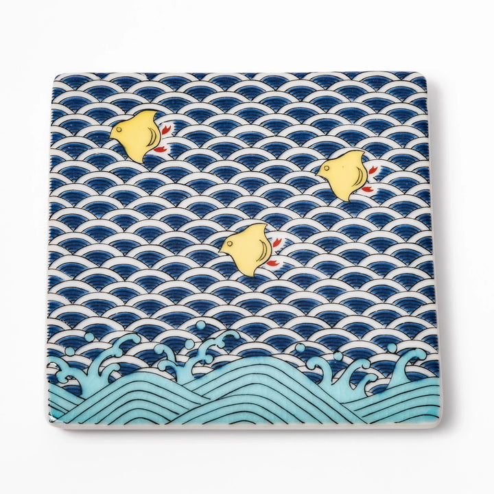 Square Japanese ceramic coaster with blue wave pattern and yellow shorebirds for artistic stylish dining.
