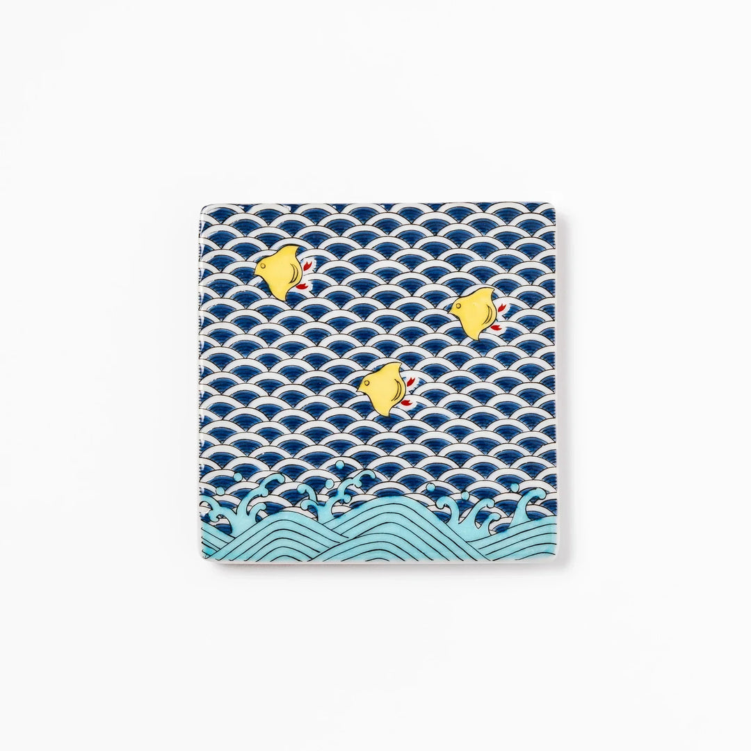 Square Japanese ceramic coaster with blue wave pattern and yellow shorebirds for artistic stylish dining.