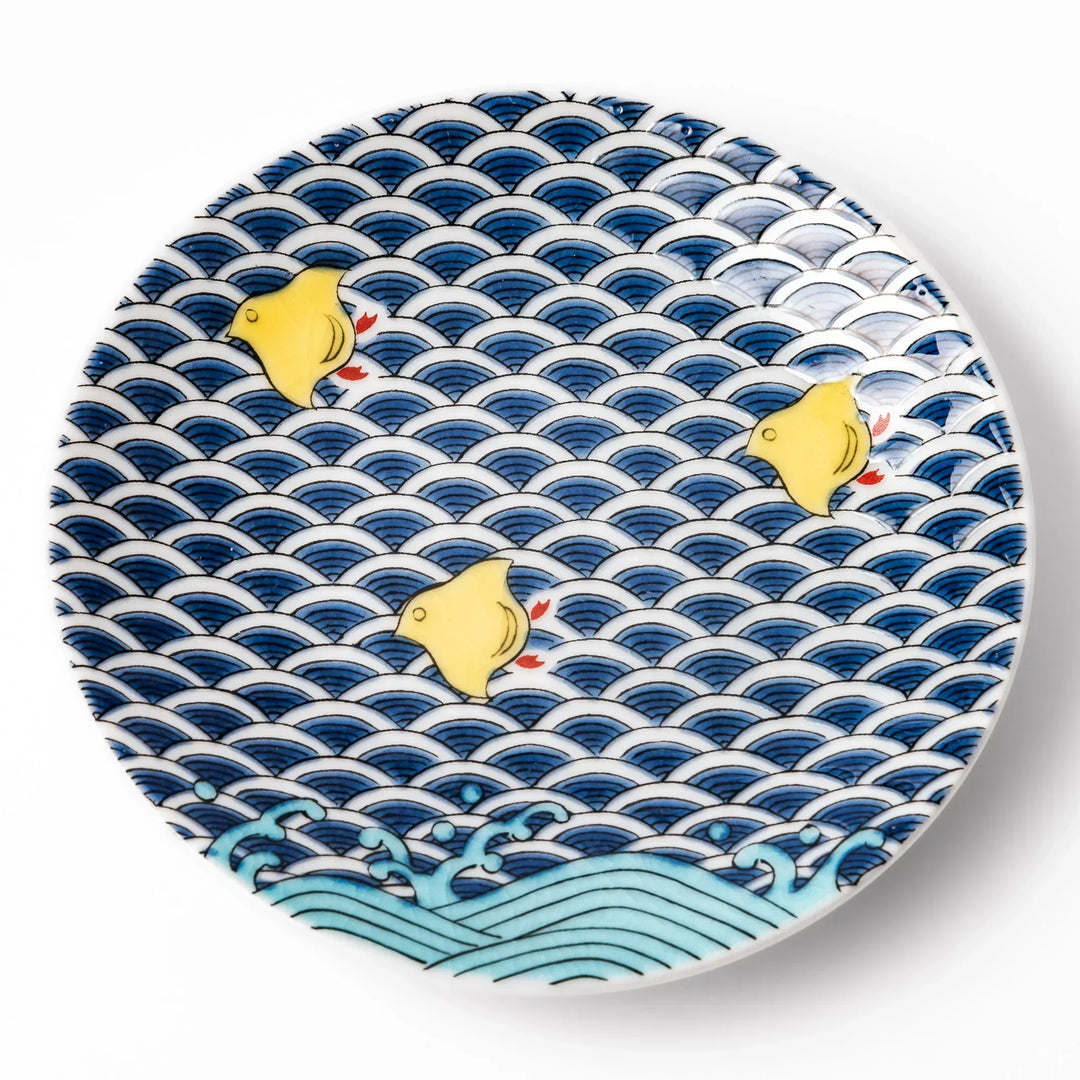 Round Japanese ceramic sauce dish with blue wave pattern and yellow shorebirds for soy sauce or condiments.