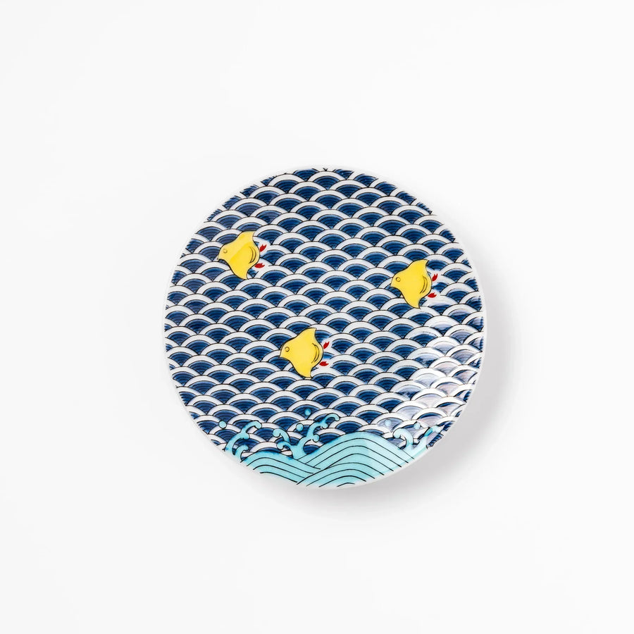 Round Japanese ceramic sauce dish with blue wave pattern and yellow shorebirds for soy sauce or condiments.
