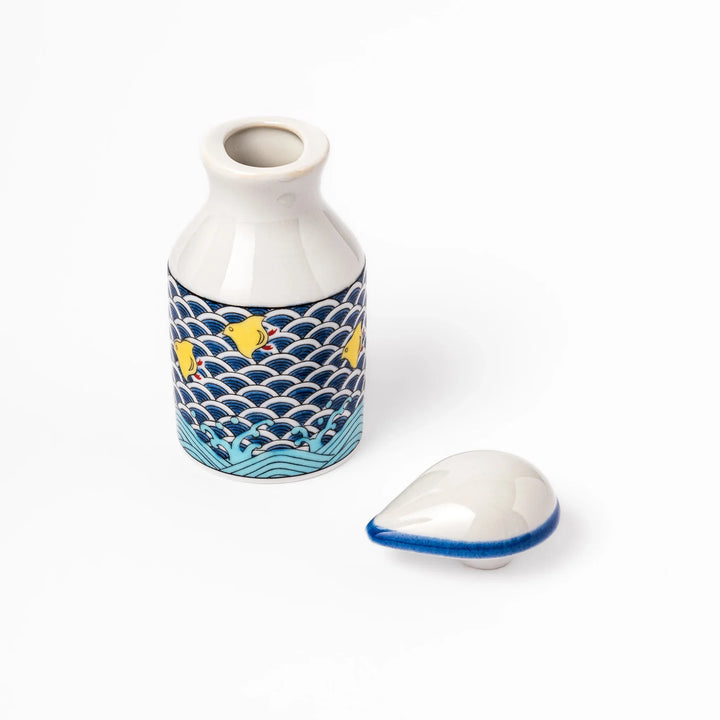 Japanese ceramic soy sauce dispenser with blue wave pattern and yellow shorebirds for traditional dining.