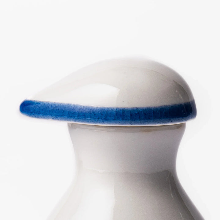 Japanese ceramic soy sauce dispenser with blue wave pattern and yellow shorebirds for traditional dining.