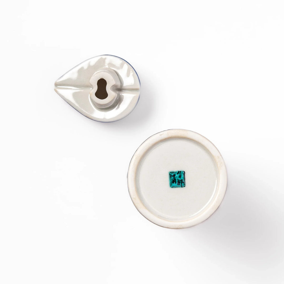 Japanese ceramic soy sauce dispenser with blue wave pattern and yellow shorebirds for traditional dining.