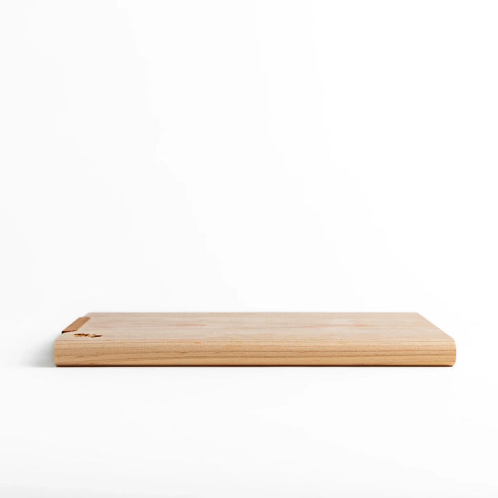 Small Hinoki wood cutting board with smooth grain, natural finish, corner handle, and engraved motif, crafted in Japan
