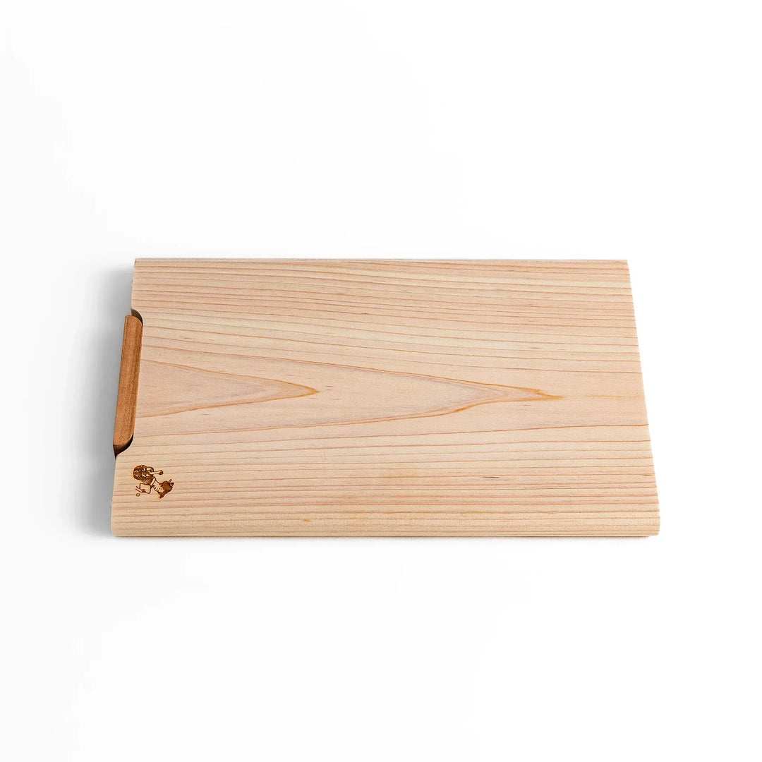 Small Hinoki wood cutting board with smooth grain, natural finish, corner handle, and engraved motif, crafted in Japan