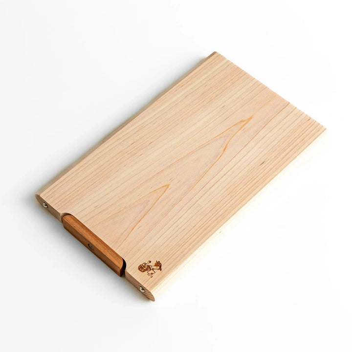 Small Hinoki wood cutting board with smooth grain, natural finish, corner handle, and engraved motif, crafted in Japan