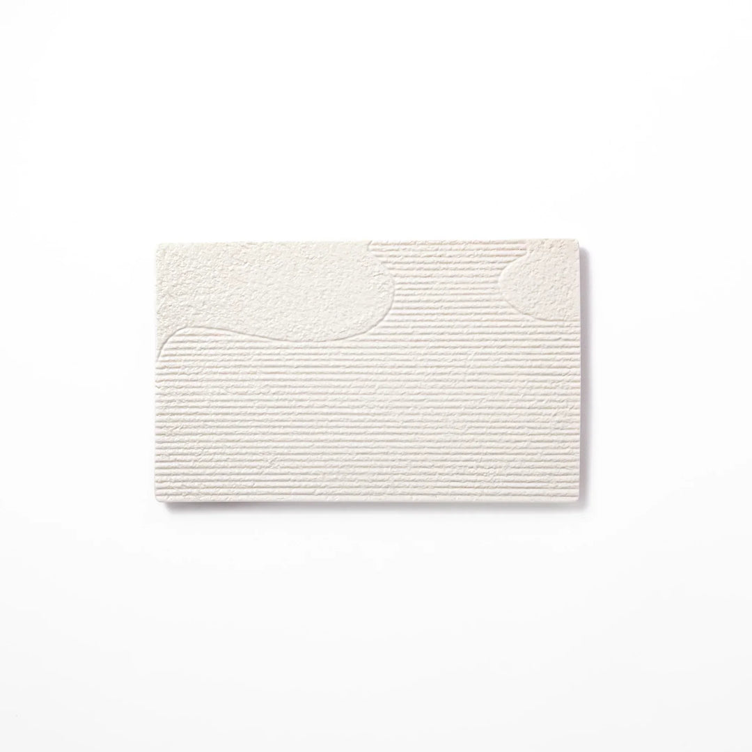 White Japanese ceramic dinner plate with ridged texture and matte gloss contrast for refined elegant dining.