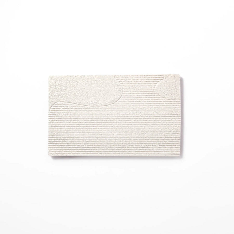 White Japanese ceramic dinner plate with ridged texture and matte gloss contrast for refined elegant dining.