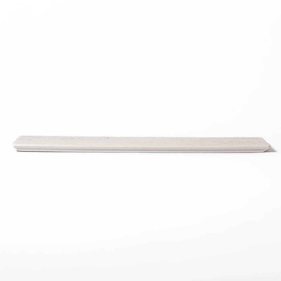 Rectangular white Japanese ceramic serving plate with ridged texture and matte gloss contrast for dining.