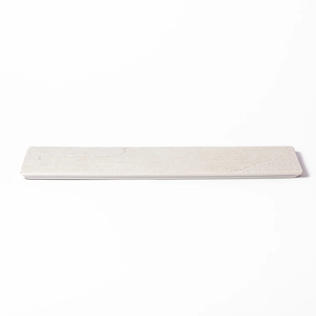 Rectangular white Japanese ceramic serving plate with ridged texture and matte gloss contrast for dining.