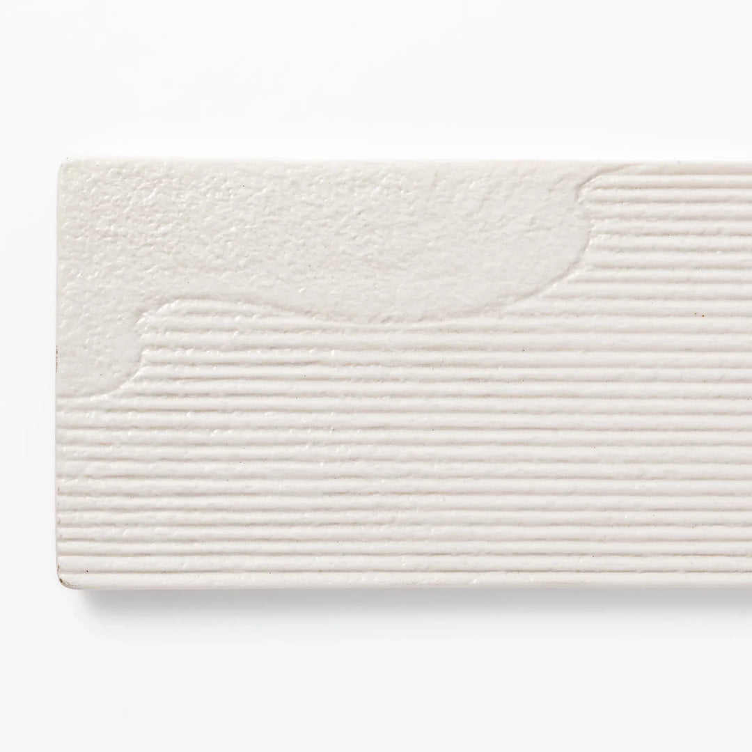 Rectangular white Japanese ceramic serving plate with ridged texture and matte gloss contrast for dining.
