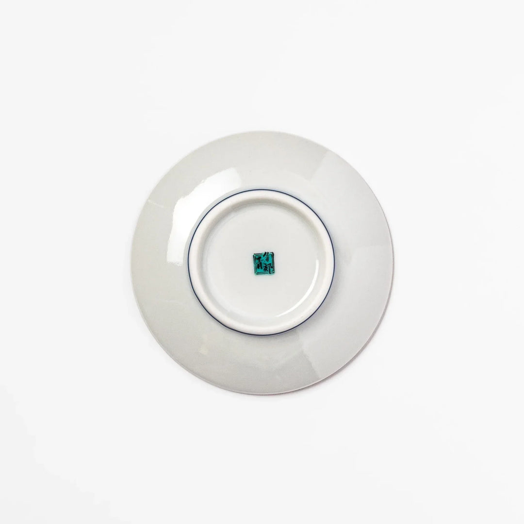 Round Japanese ceramic sauce dish with teal background and white blue plum blossom motifs for condiments.