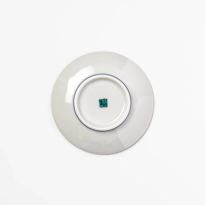 Round Japanese ceramic sauce dish with teal background and white blue plum blossom motifs for condiments.