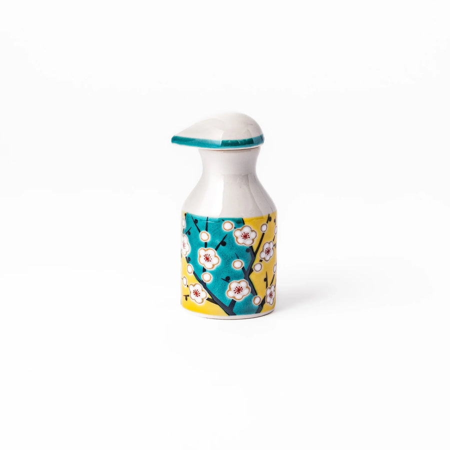 Japanese ceramic soy sauce dispenser with teal lid and yellow body with white plum blossoms made in Arita.