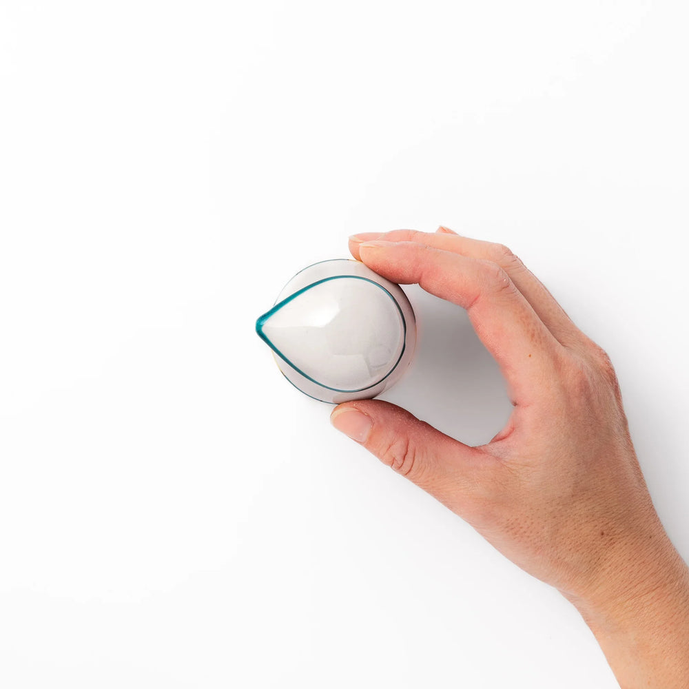 Japanese ceramic soy sauce dispenser with teal lid and yellow body with white plum blossoms made in Arita.