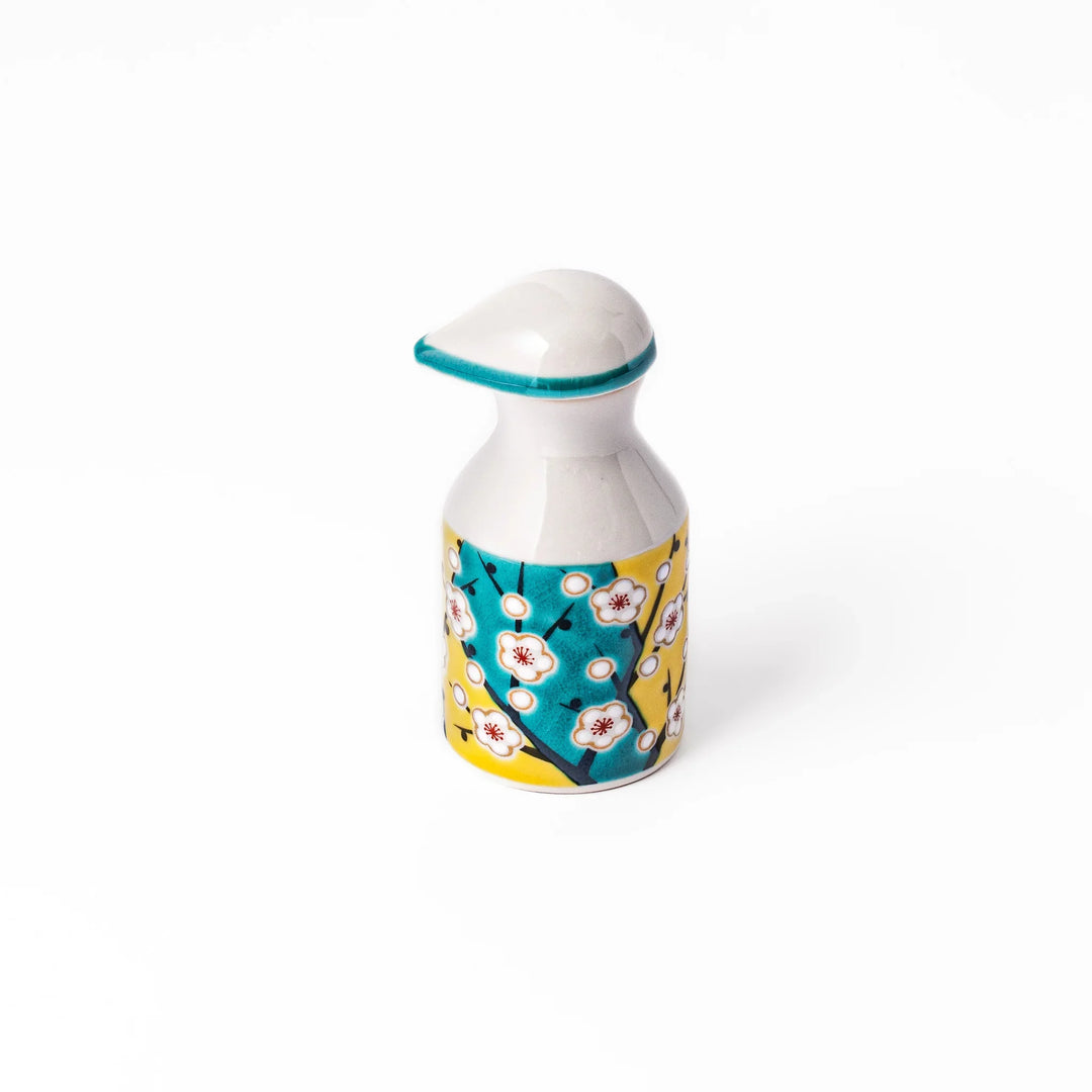 Japanese ceramic soy sauce dispenser with teal lid and yellow body with white plum blossoms made in Arita.