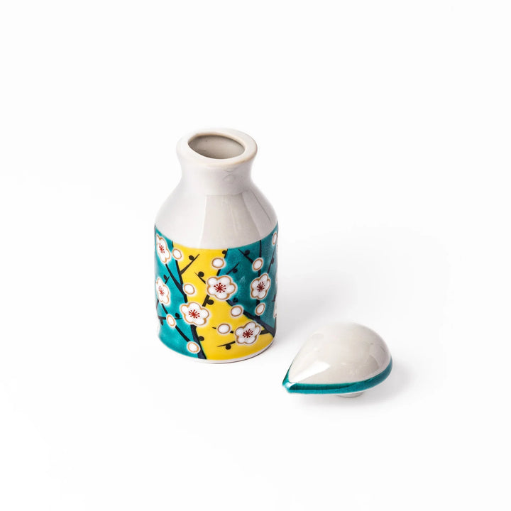 Japanese ceramic soy sauce dispenser with teal lid and yellow body with white plum blossoms made in Arita.