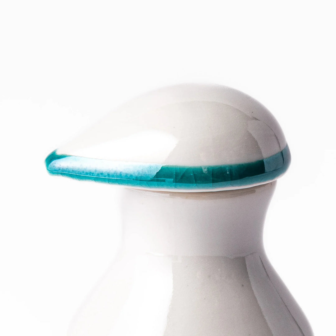 Japanese ceramic soy sauce dispenser with teal lid and yellow body with white plum blossoms made in Arita.