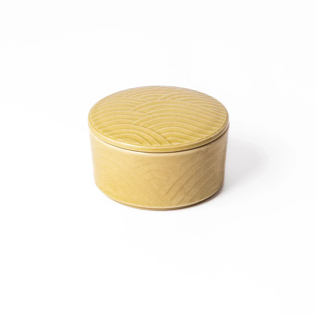 Yellow Japanese porcelain bowl with embossed Seigaiha wave pattern smooth matte glaze and modern design.