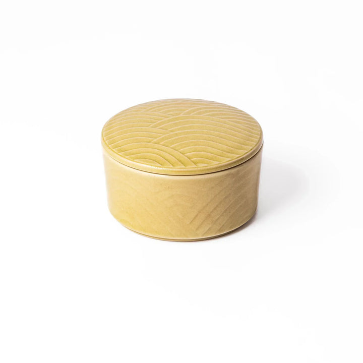Yellow Japanese porcelain bowl with embossed Seigaiha wave pattern smooth matte glaze and modern design.