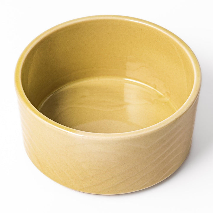 Yellow Japanese porcelain bowl with embossed Seigaiha wave pattern smooth matte glaze and modern design.