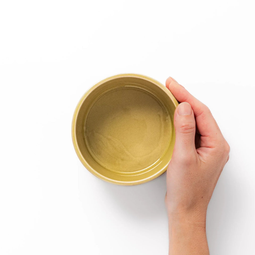 Yellow Japanese porcelain bowl with embossed Seigaiha wave pattern smooth matte glaze and modern design.
