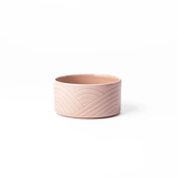 Soft pink stackable Japanese porcelain bowl with embossed Seigaiha wave pattern and modern minimalist style.