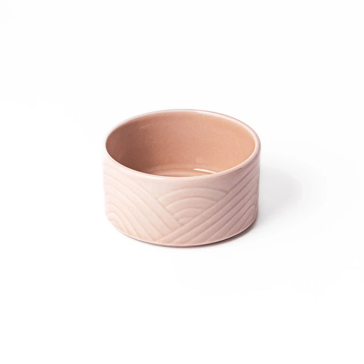 Soft pink stackable Japanese porcelain bowl with embossed Seigaiha wave pattern and modern minimalist style.