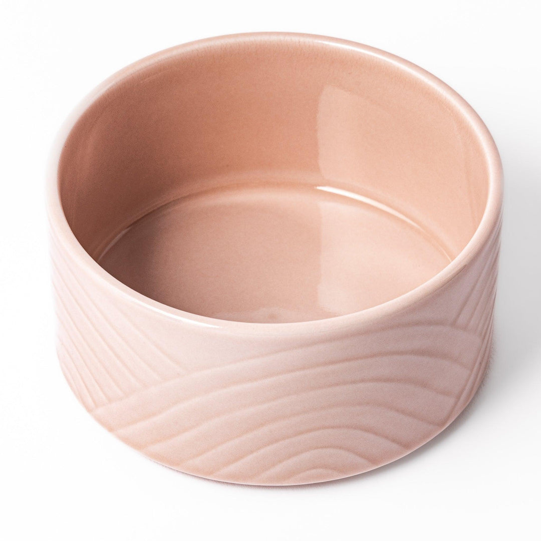 Soft pink stackable Japanese porcelain bowl with embossed Seigaiha wave pattern and modern minimalist style.