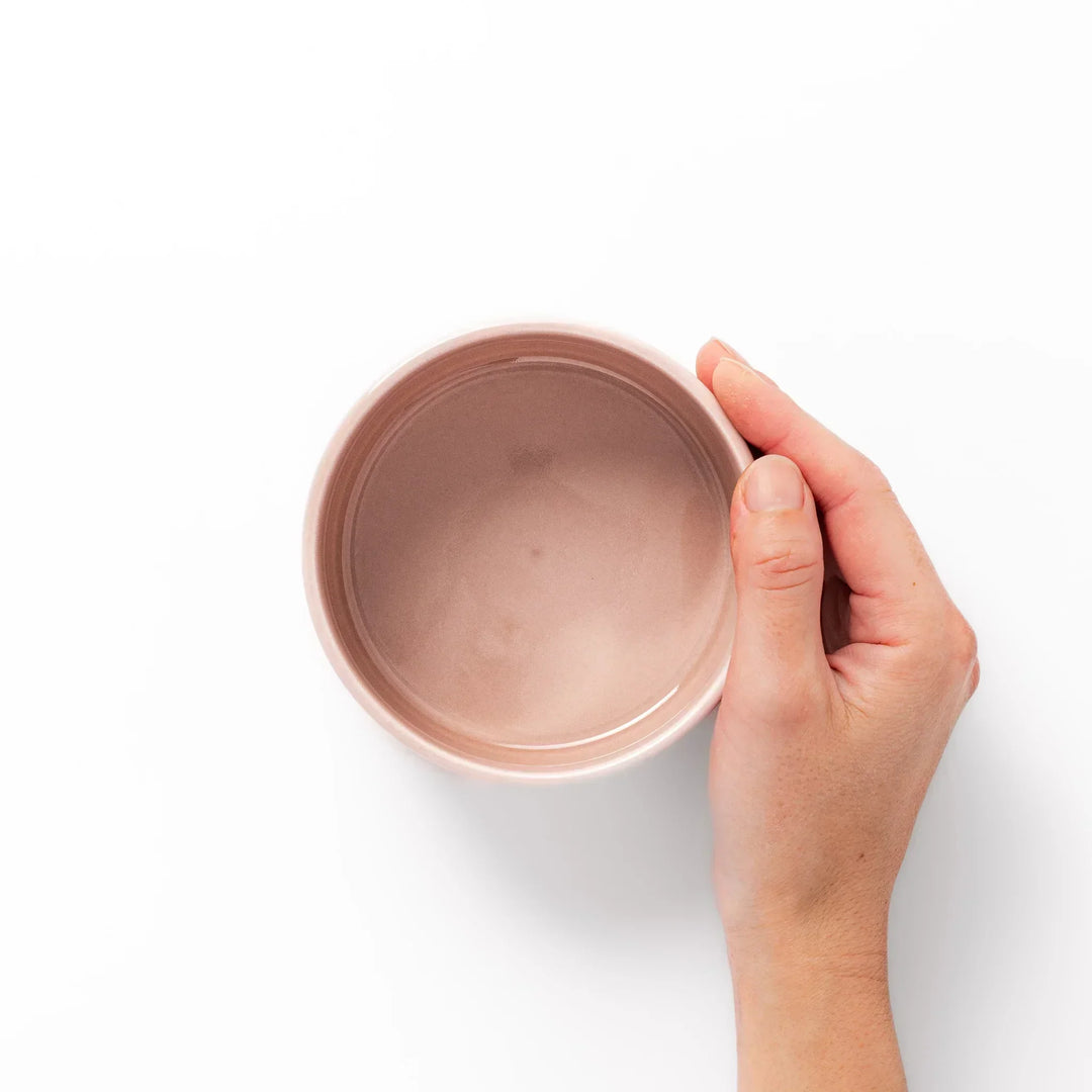 Soft pink stackable Japanese porcelain bowl with embossed Seigaiha wave pattern and modern minimalist style.