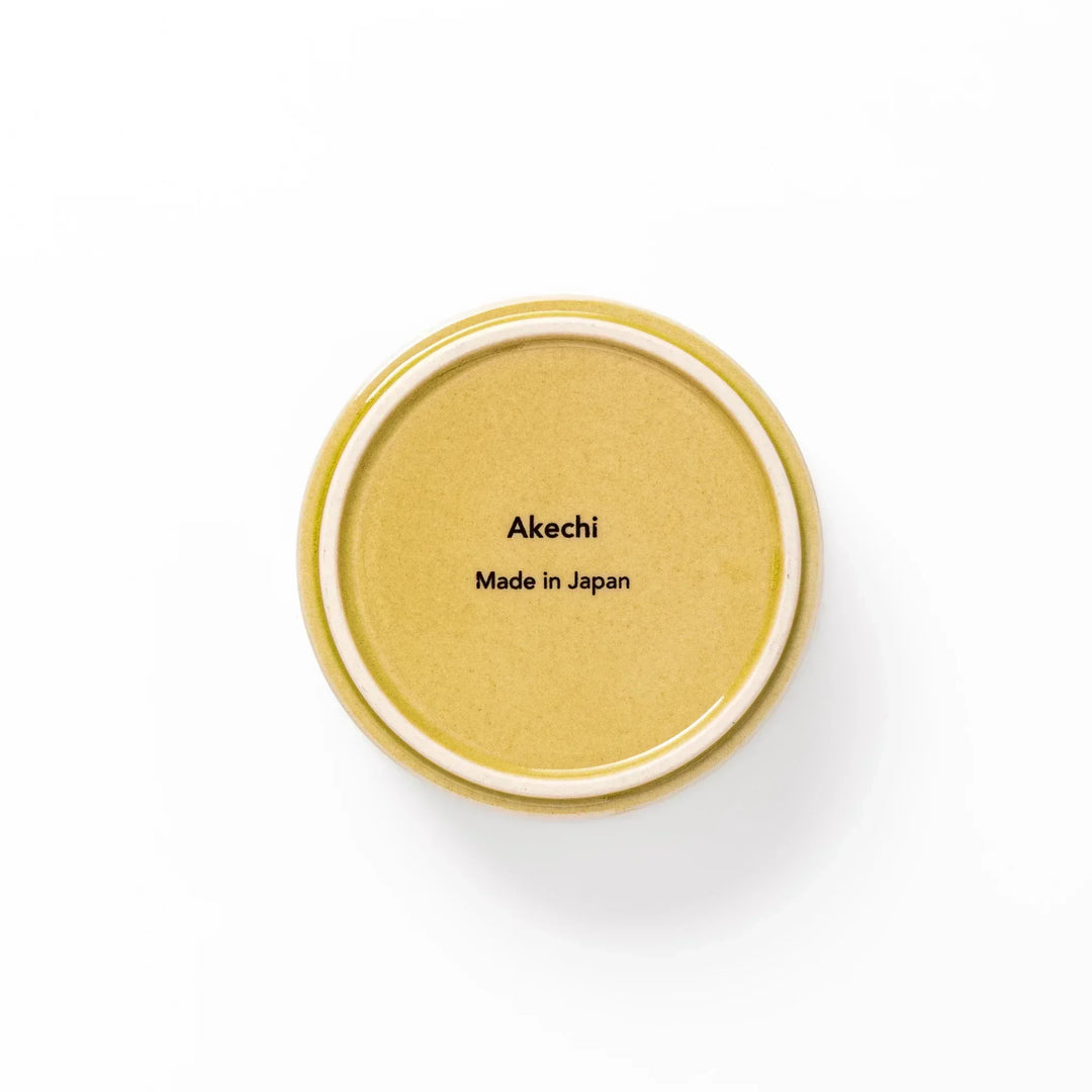 Small yellow Japanese porcelain bowl with embossed Seigaiha wave pattern matte finish and minimalist design.