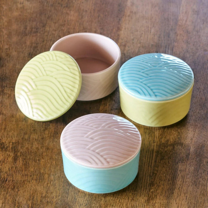 Stackable Japanese porcelain boxes in yellow blue and pink with wave lids for condiments or small treats.