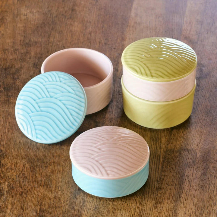 Stackable Japanese porcelain boxes in yellow blue and pink with wave lids for condiments or small treats.