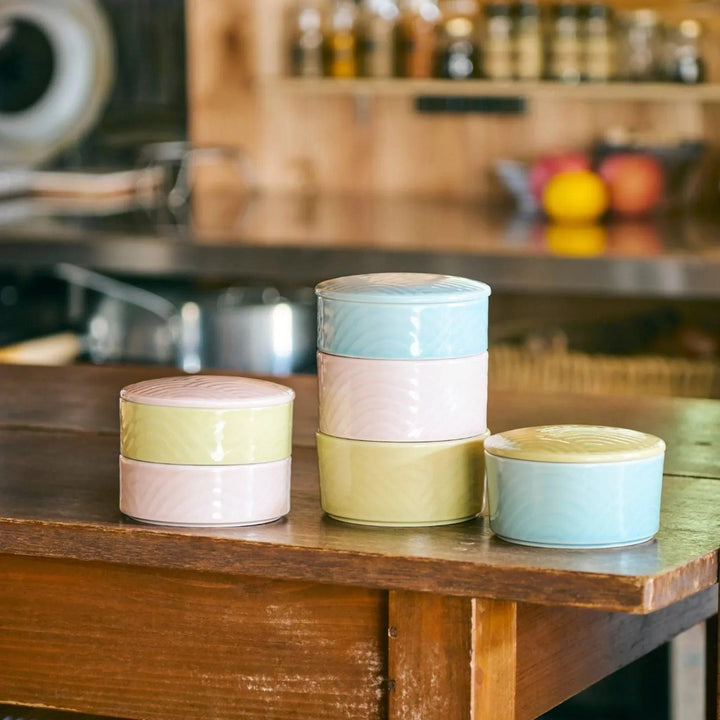 Stackable Japanese porcelain boxes in yellow blue and pink with wave lids for condiments or small treats.