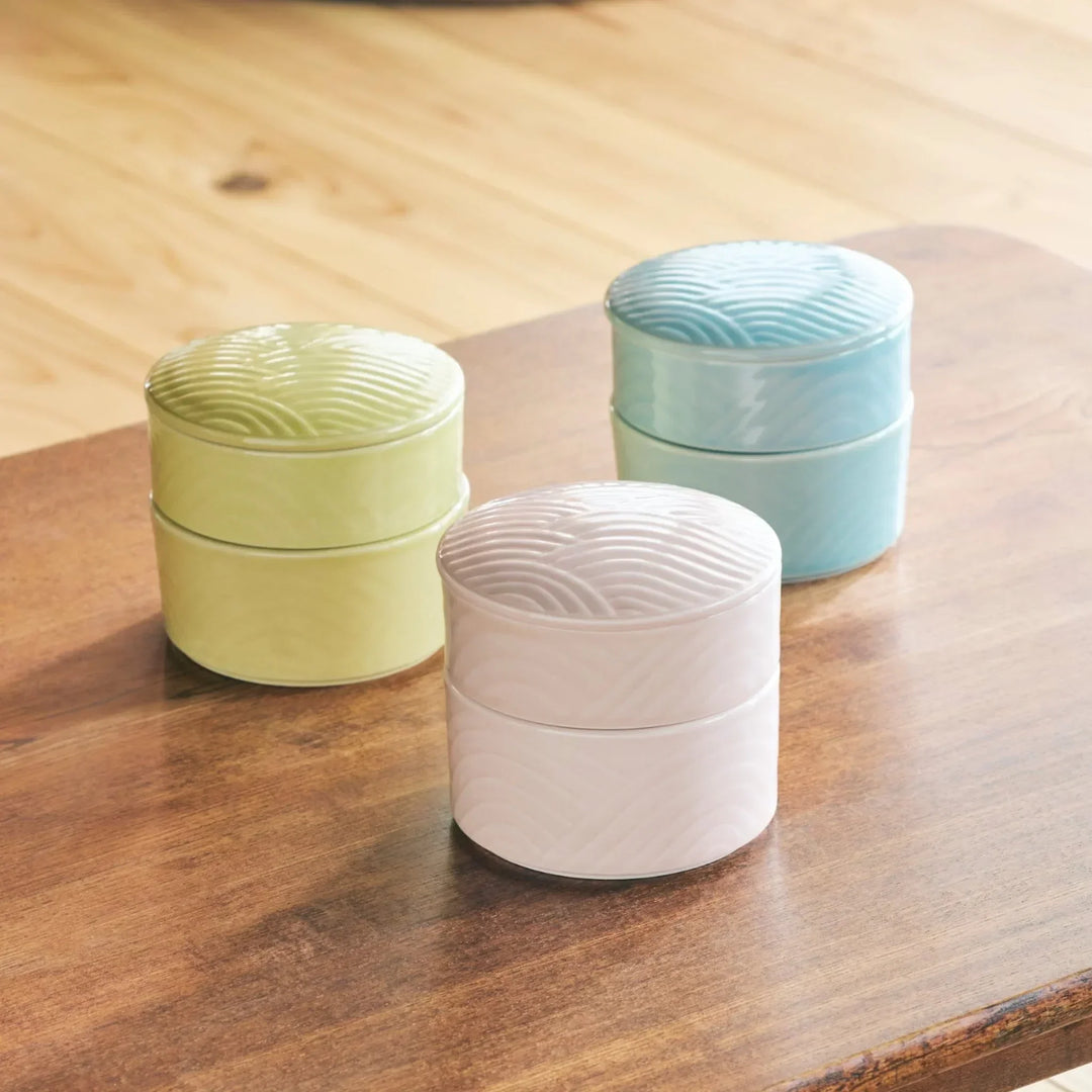 Stackable Japanese porcelain boxes in yellow blue and pink with wave lids for condiments or small treats.