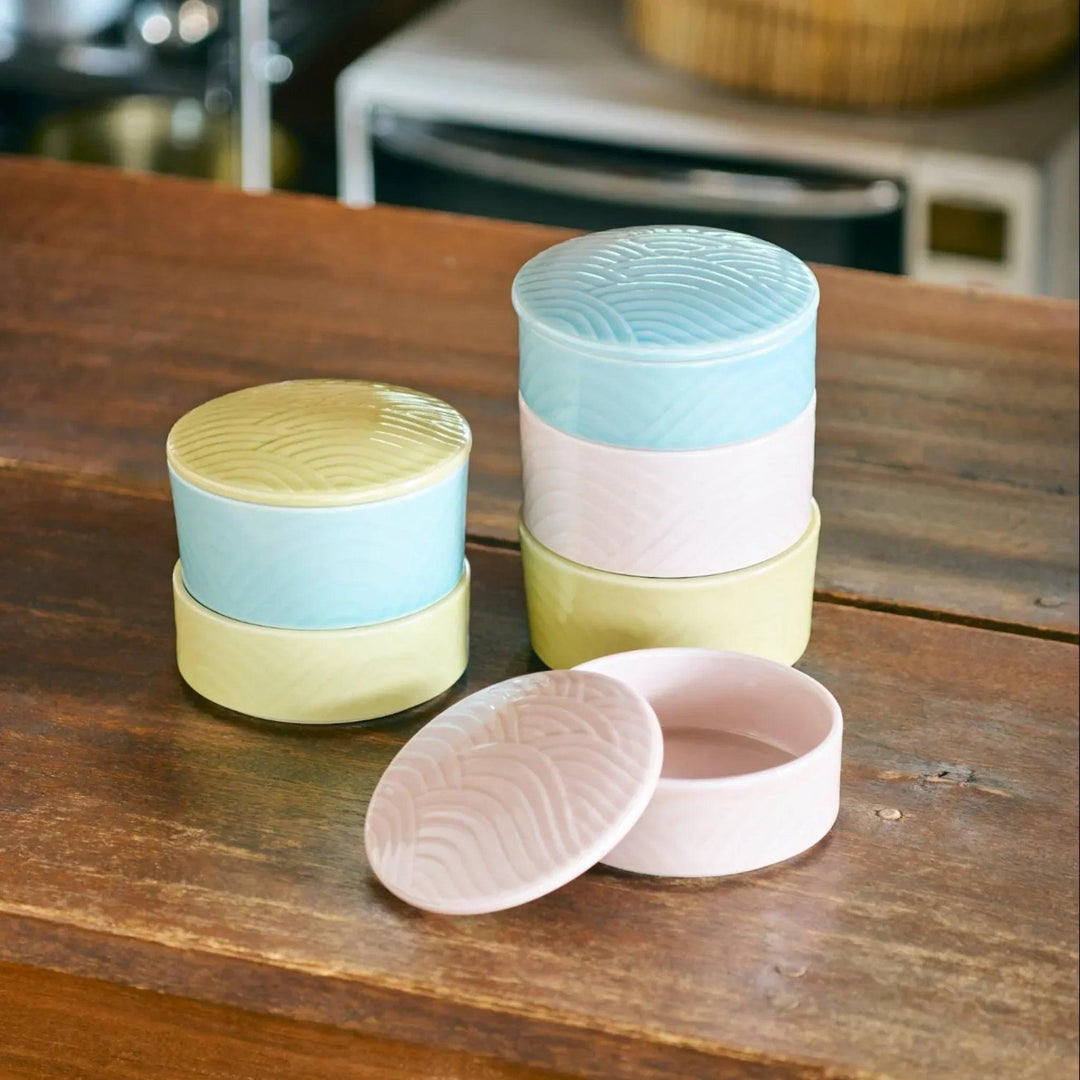 Stackable Japanese porcelain boxes in yellow blue and pink with wave lids for condiments or small treats.