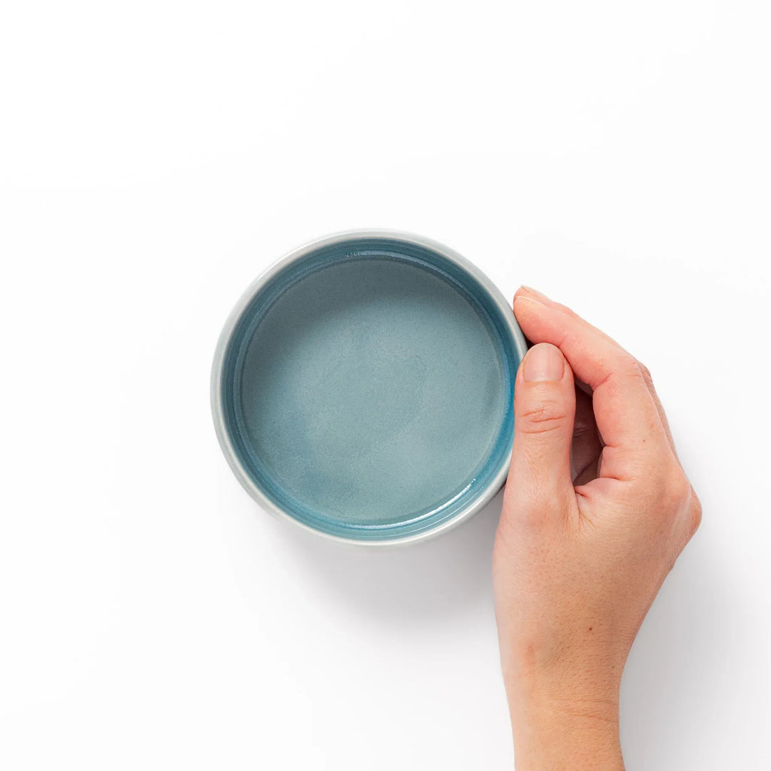 Light blue porcelain bowl embossed with a gentle Seigaiha wave pattern, showcasing a serene and minimalist Japanese design.