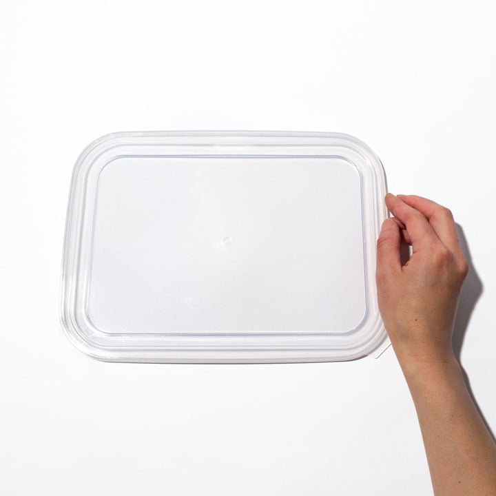Transparent lids for stainless prep trays with snug fit and durable seal, ideal for efficient food storage.