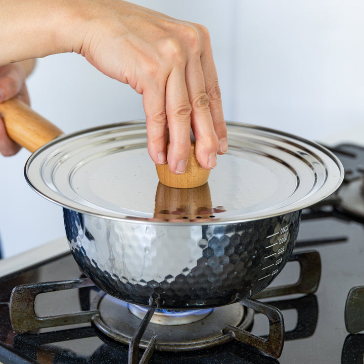 Stainless Steel Yukihira Pot with lid over blue gas flame