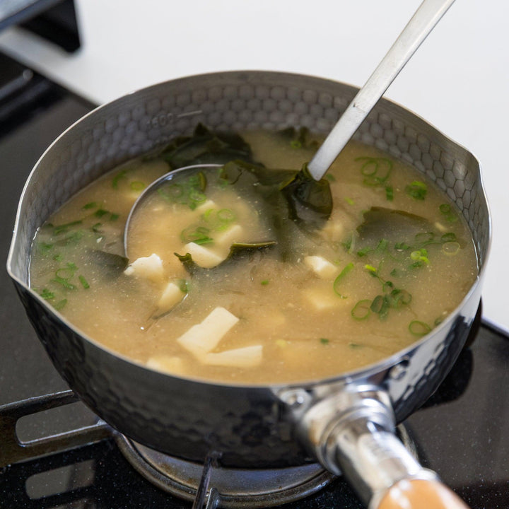 Stainless Steel Yukihira Pot cooking miso soup with tofu wakame and green onion