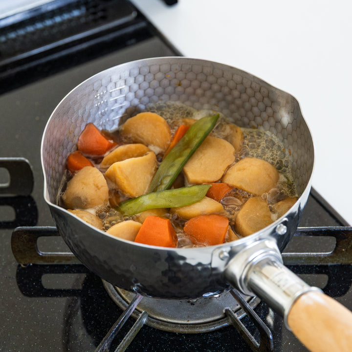 Stainless Steel Yukihira Pot simmering root vegetables and snap peas