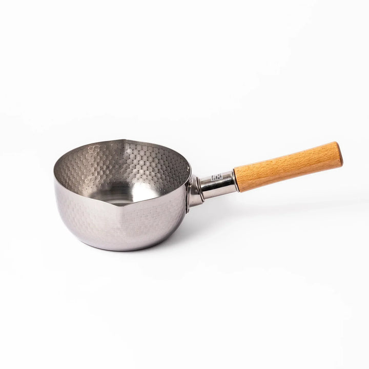 Japanese stainless steel yukihira pot with wooden handle and hammered texture, ideal for boiling soup or simmering dishes
