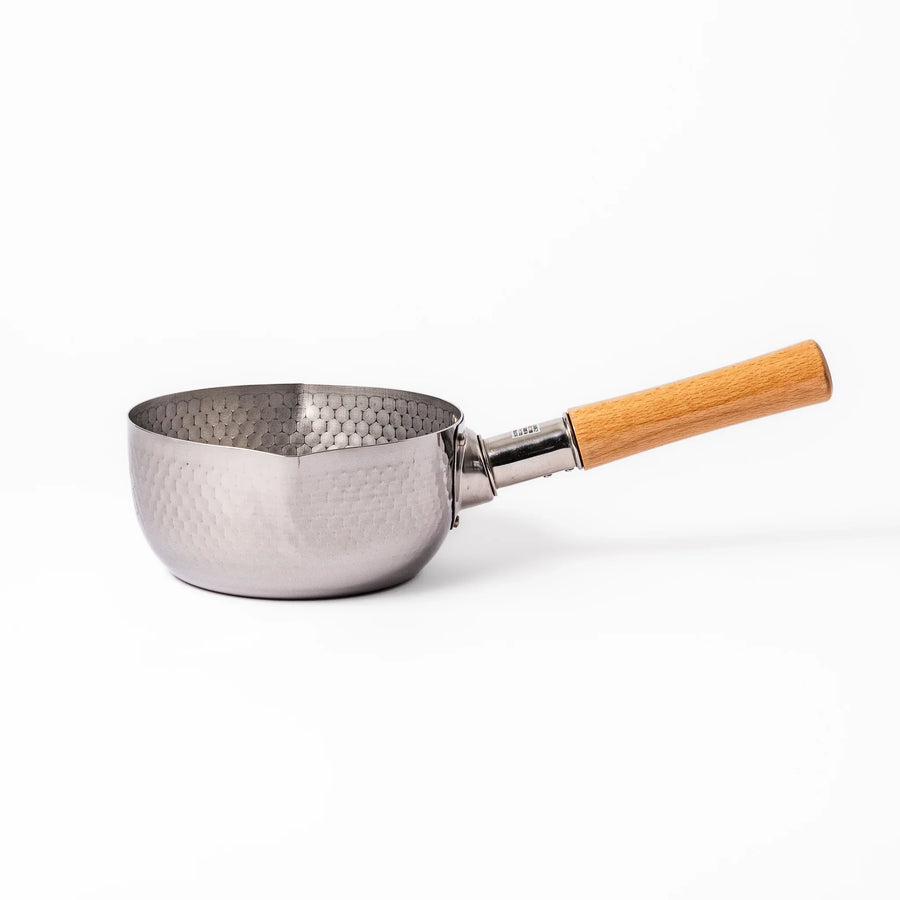 Japanese stainless steel yukihira pot with wooden handle and hammered texture, ideal for boiling soup or simmering dishes