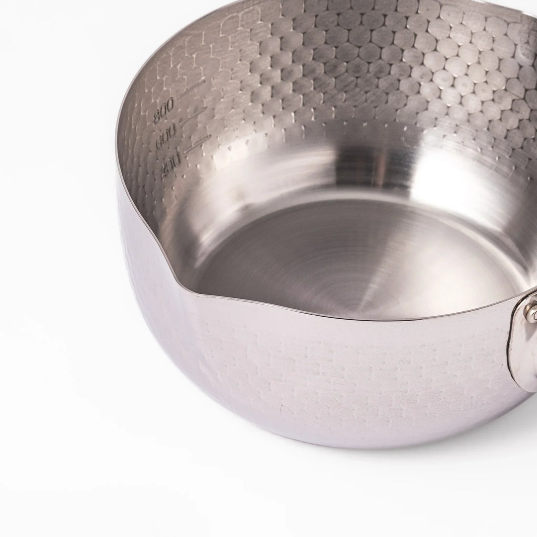 Japanese stainless steel yukihira pot with wooden handle and hammered texture, ideal for boiling soup or simmering dishes