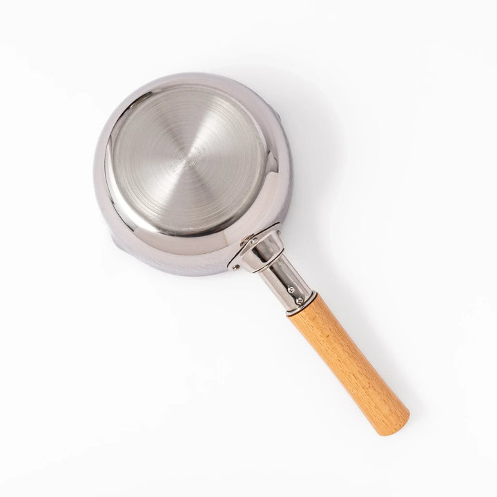 Japanese stainless steel yukihira pot with wooden handle and hammered texture, ideal for boiling soup or simmering dishes