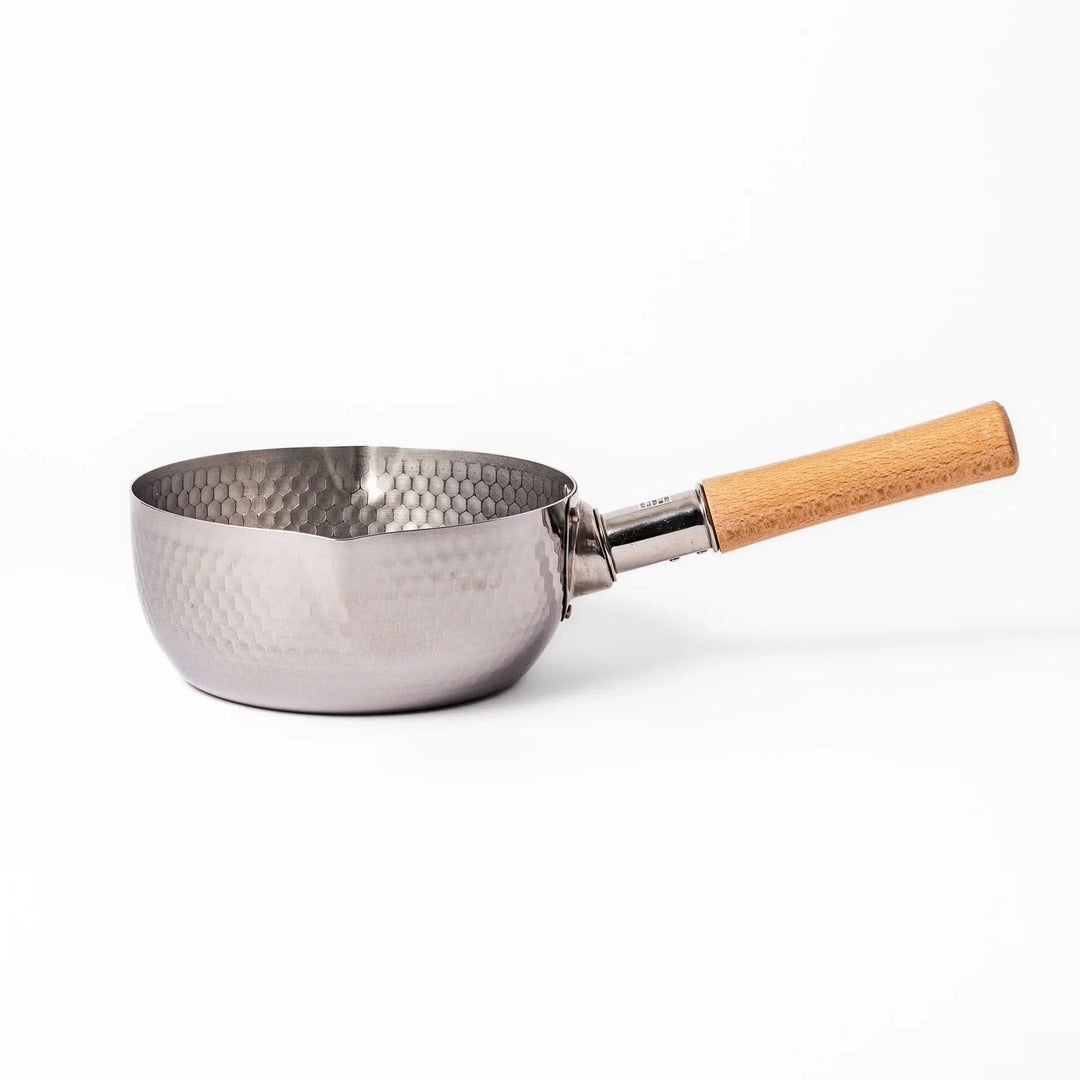 Stainless steel Yukihira pot with a wooden handle featuring a hammered texture and dual pour spouts.