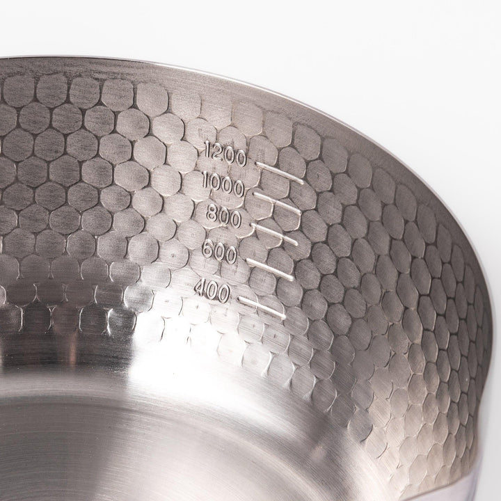 Stainless steel Yukihira pot with a wooden handle featuring a hammered texture and dual pour spouts.